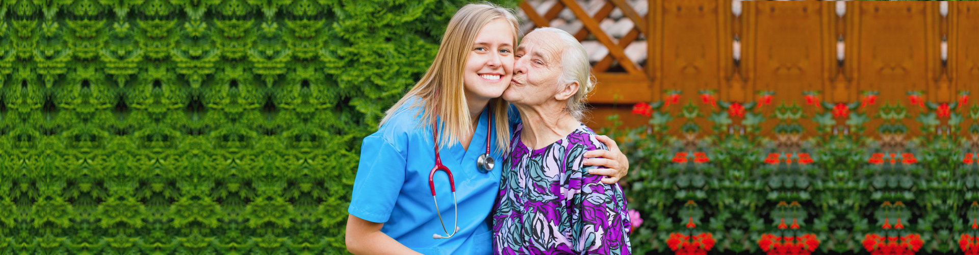 an elderly woman kissing a female caregiver